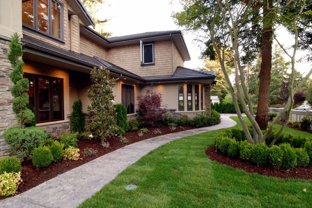 Custom residential estate design by a certified landscaper in Johnston, IA, featuring Zone 5 freeze-tolerant native perennials, drip irrigation, and drought-resistant turf.